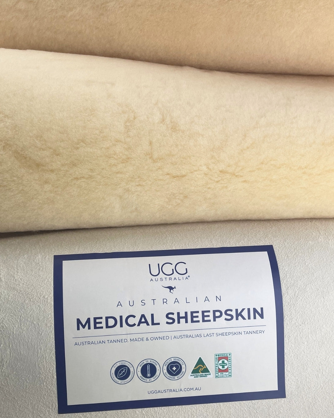 Sheepskin fabric with a label indicating 'Australian Medical Sheepskin' on a beige background.